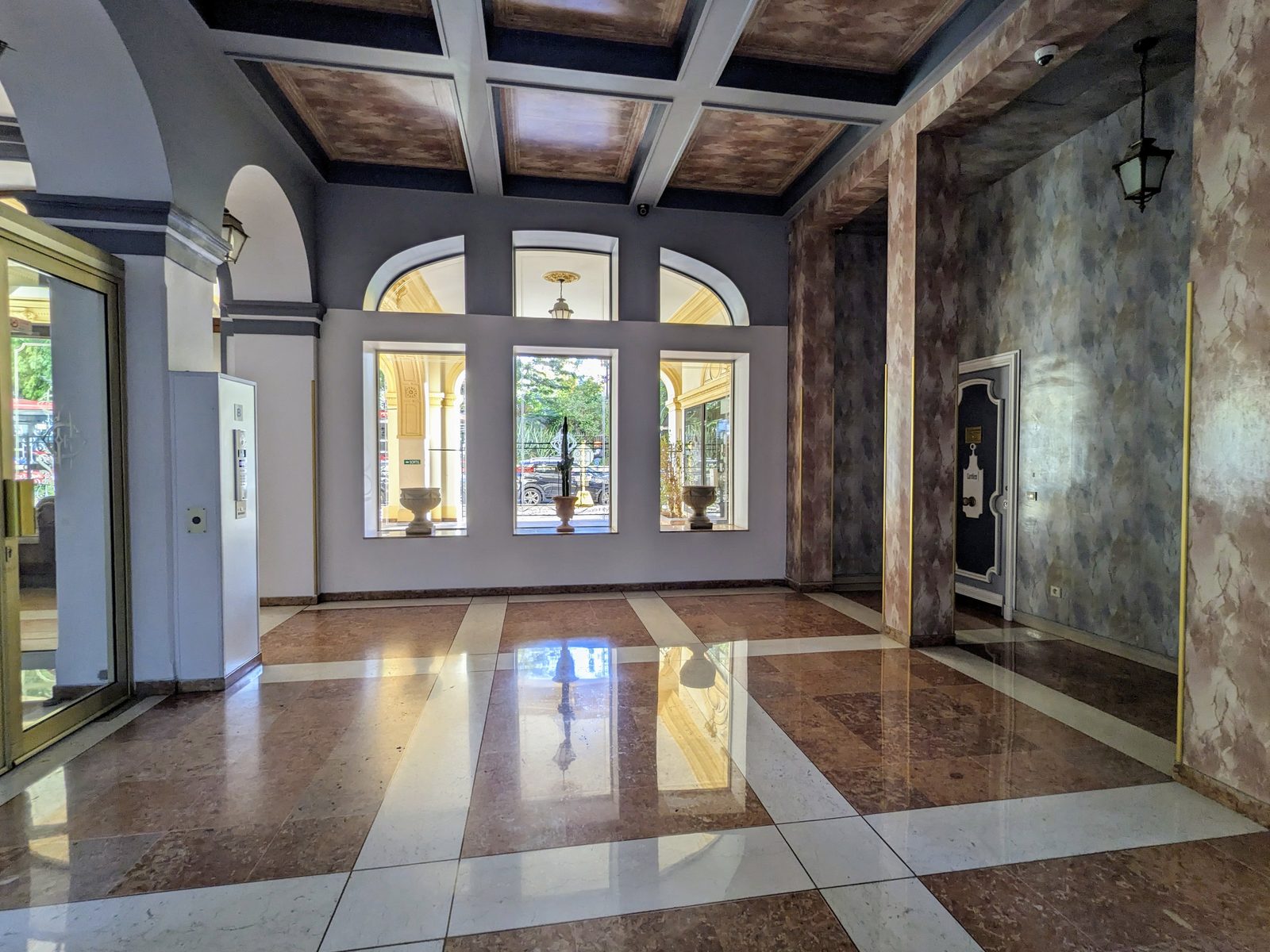 The entrance hall of Le Grand Hôtel in Nice, coffered ceiling and marble floor