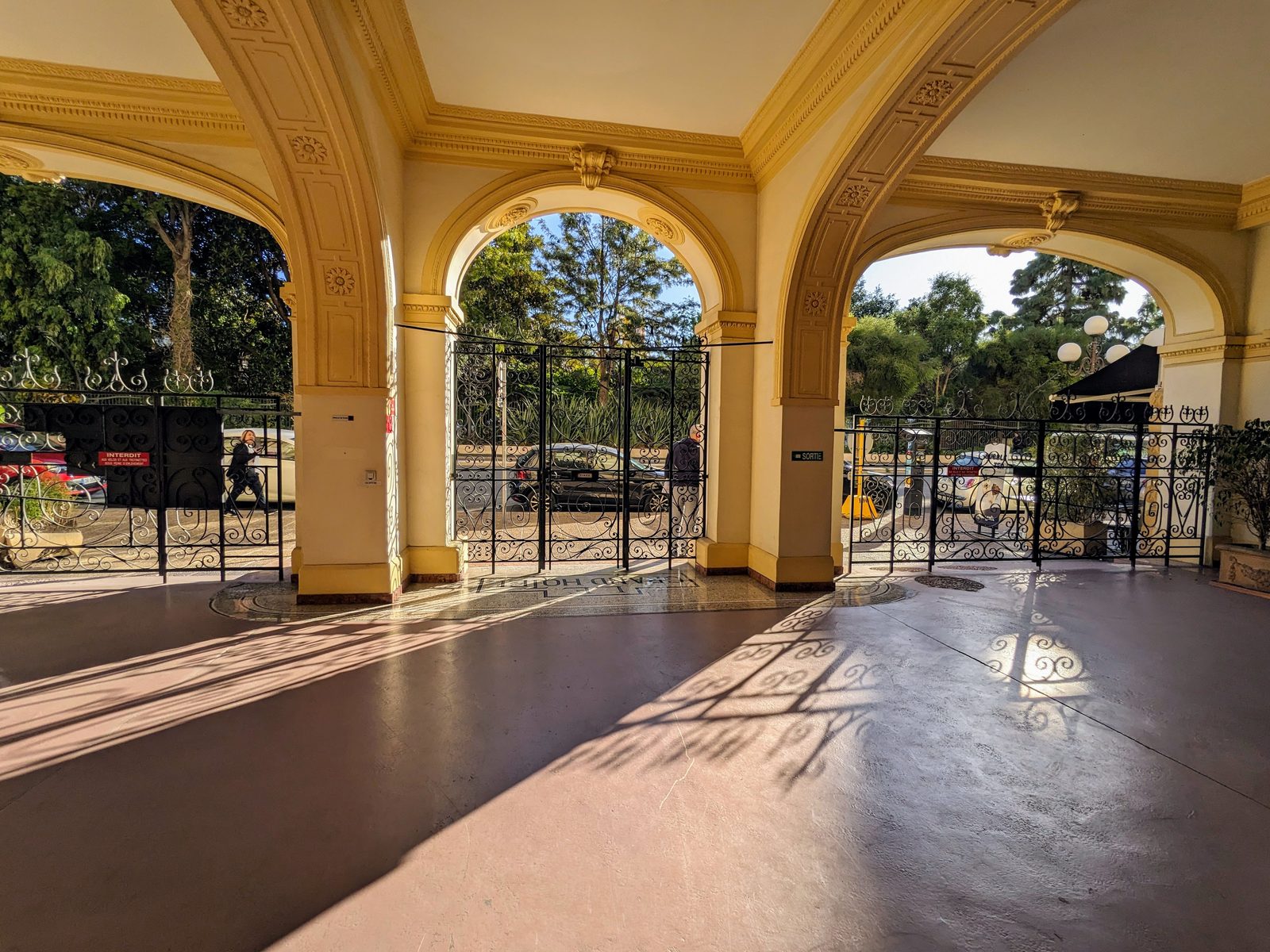 The entrance porch of Le Grand Hôtel in Nice, arches and wrought-iron gates