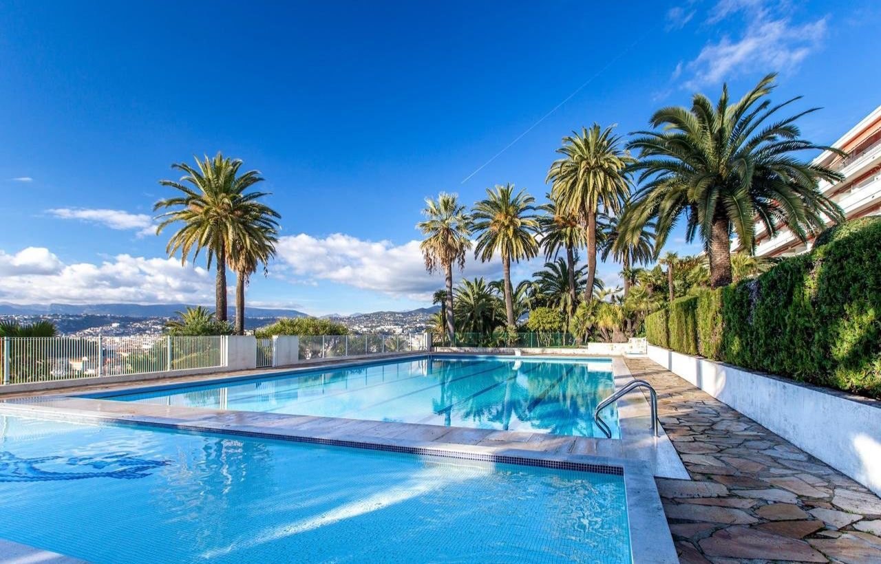 The Parc Haussmann swimming pool among palm trees, overlooking Nice