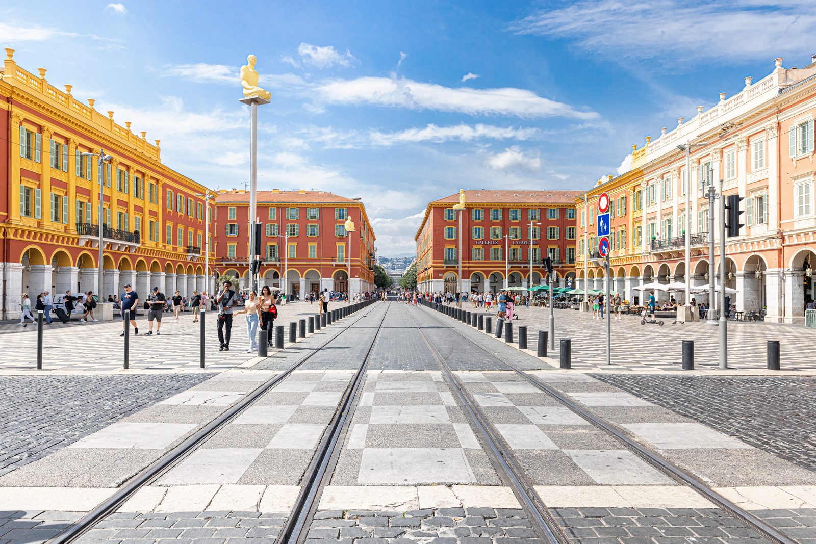 Place Masséna, its red arcaded façades and statues, in Nice